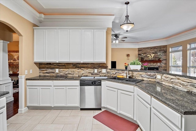 kitchen featuring arched walkways, ornamental molding, decorative backsplash, a sink, and dishwasher