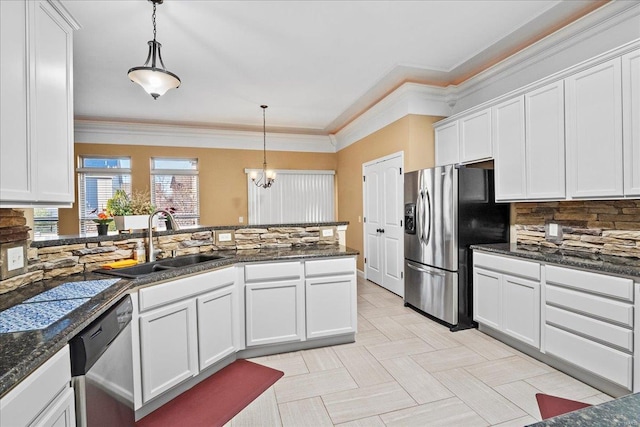 kitchen featuring backsplash, crown molding, appliances with stainless steel finishes, white cabinets, and a sink