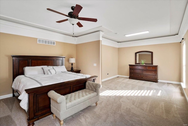 bedroom with a ceiling fan, visible vents, baseboards, crown molding, and light colored carpet