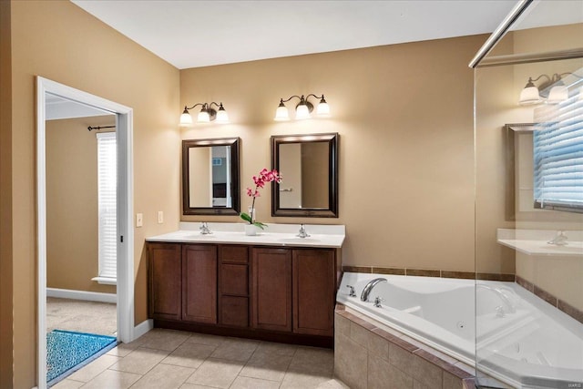 full bathroom featuring tile patterned flooring, a whirlpool tub, and a sink