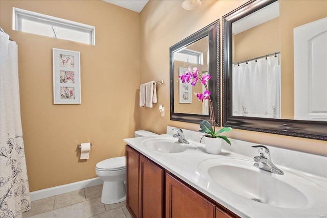 bathroom with a sink, baseboards, toilet, and tile patterned flooring