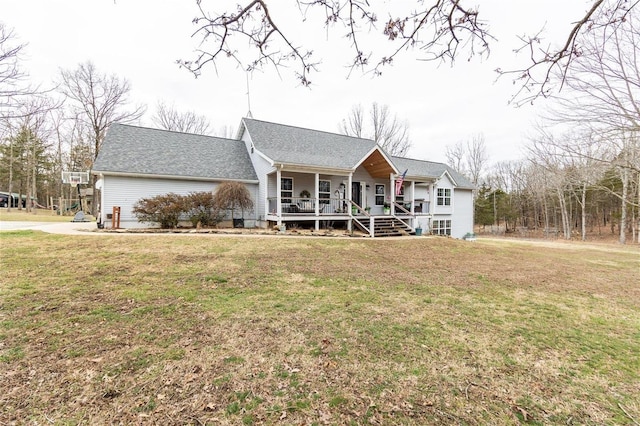 view of front of property with a front lawn, a porch, and a shingled roof