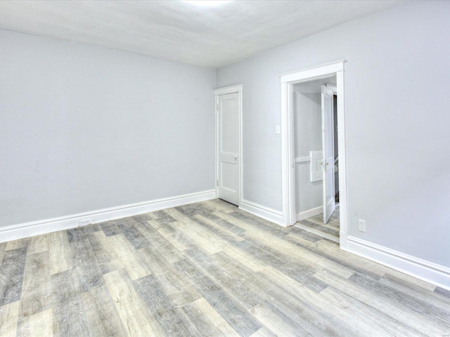 unfurnished bedroom featuring baseboards and wood finished floors