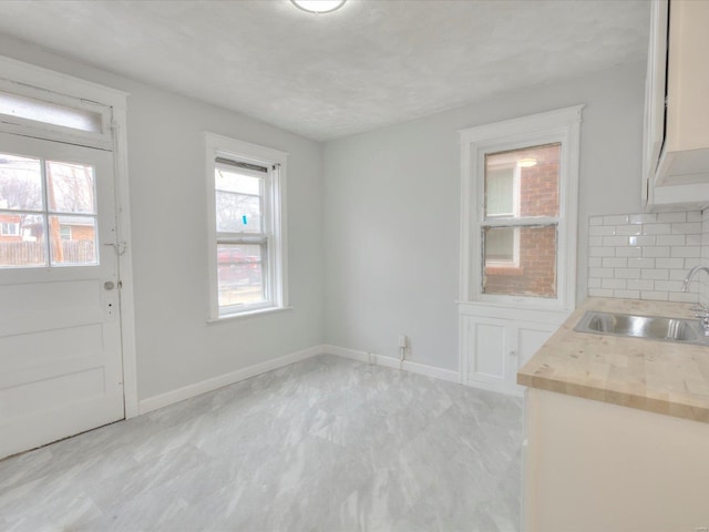 interior space featuring a sink and baseboards