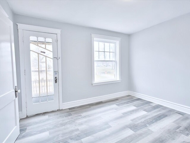 interior space with baseboards and wood finished floors