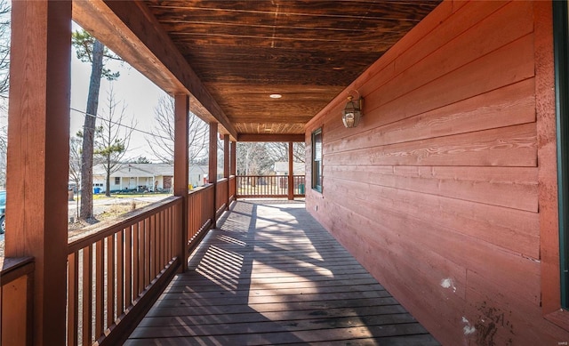 wooden deck featuring a residential view and covered porch