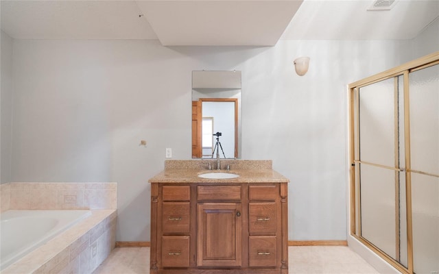 bathroom with vanity, a bath, baseboards, and a stall shower