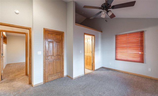 unfurnished bedroom featuring baseboards, a ceiling fan, carpet flooring, and vaulted ceiling