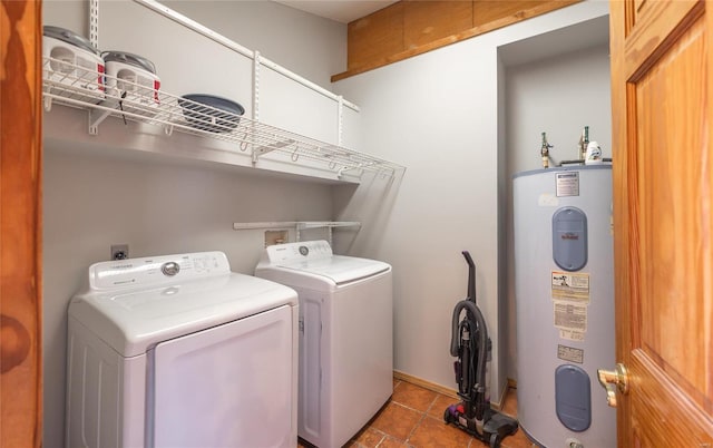 laundry area featuring tile patterned floors, laundry area, electric water heater, and separate washer and dryer