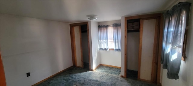 unfurnished bedroom with a closet, baseboards, and carpet floors