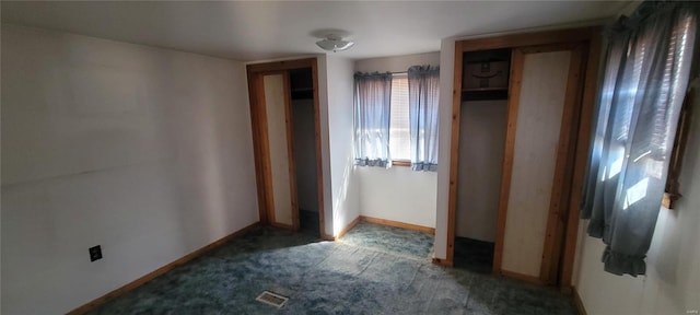 interior space featuring visible vents, baseboards, and carpet floors