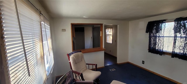 living area with visible vents and baseboards