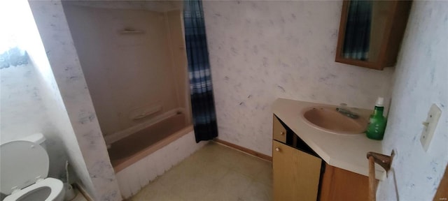 bathroom with tile patterned floors, toilet, shower / bath combo, wallpapered walls, and vanity