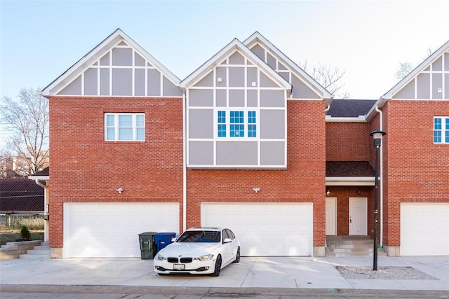 view of front of home featuring brick siding, driveway, and an attached garage