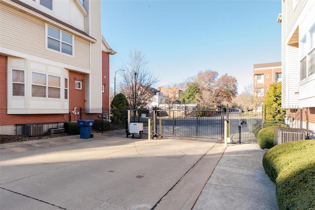 view of road with a residential view, a gated entry, and a gate