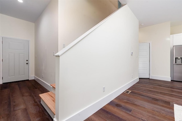 interior space with wood finished floors, visible vents, and baseboards