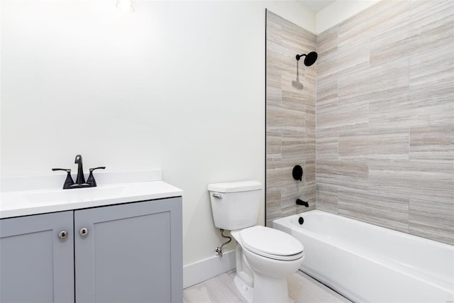 bathroom featuring bathing tub / shower combination, baseboards, toilet, and vanity