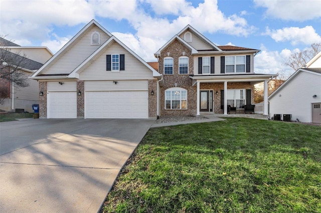 view of front of home with a front lawn, brick siding, covered porch, and driveway