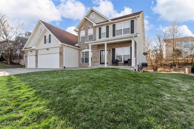 view of front of house featuring a front yard, driveway, an attached garage, covered porch, and brick siding