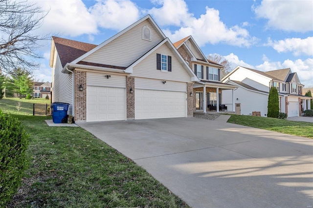 view of front of house with brick siding, driveway, a front yard, and fence