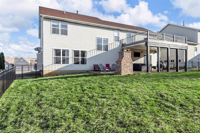 rear view of house with a yard, a patio, and fence