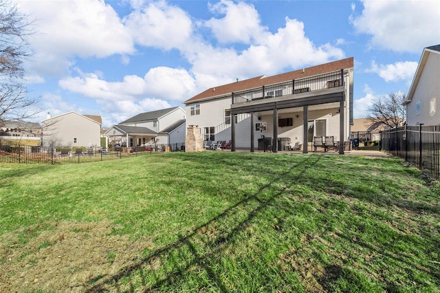 back of house with a yard, a residential view, a fenced backyard, and a patio area