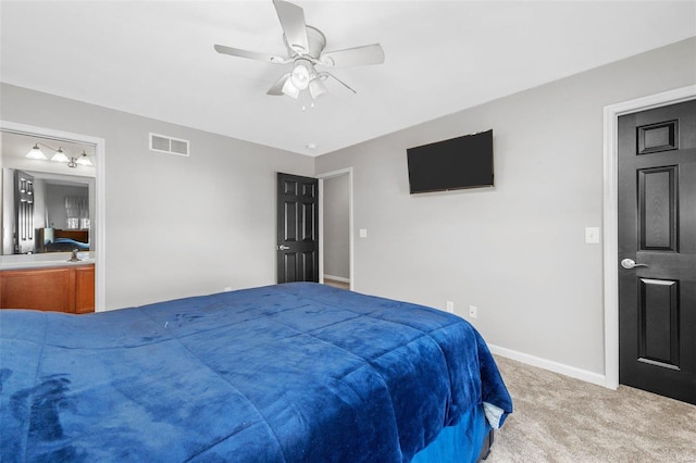 carpeted bedroom featuring visible vents, baseboards, a ceiling fan, and ensuite bathroom