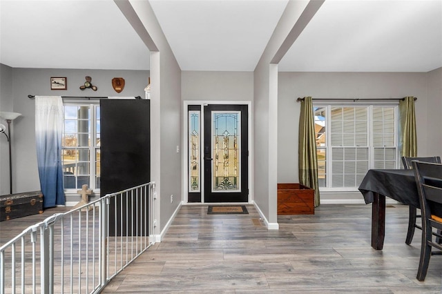 entryway featuring wood finished floors and baseboards