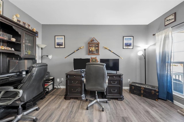 office space featuring baseboards and wood finished floors