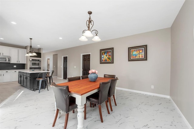 dining room with recessed lighting, marble finish floor, and baseboards