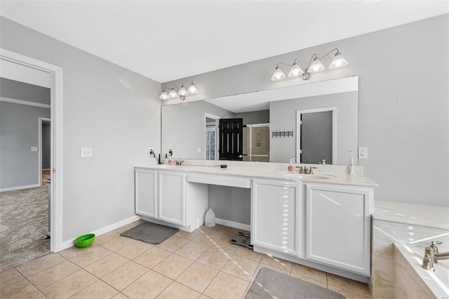 full bathroom with tile patterned floors, baseboards, double vanity, and a sink