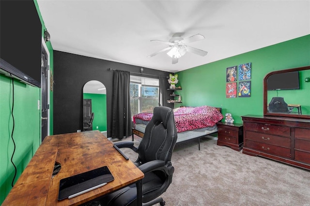 bedroom featuring arched walkways, carpet floors, and ceiling fan