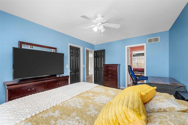 bedroom with baseboards, visible vents, and ceiling fan