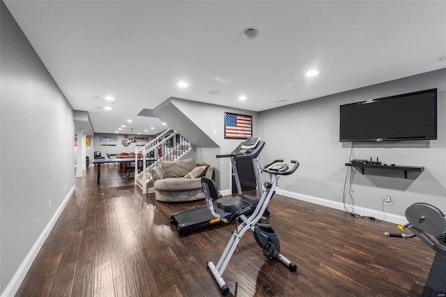 workout room featuring recessed lighting, baseboards, and wood finished floors