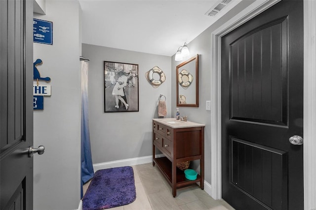 full bathroom with vanity, baseboards, visible vents, and tile patterned flooring