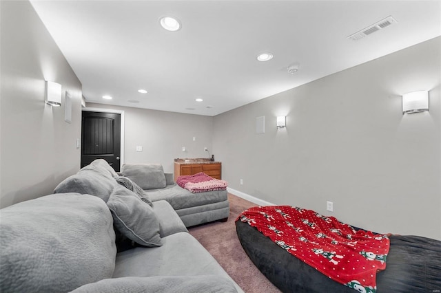 carpeted living area with recessed lighting, visible vents, and baseboards