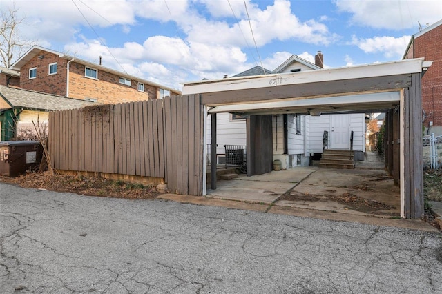 garage featuring central air condition unit and fence