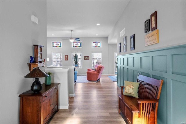 hall with recessed lighting, light wood-type flooring, and baseboards