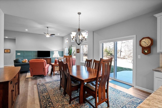 dining room featuring ceiling fan with notable chandelier, recessed lighting, wood finished floors, and baseboards