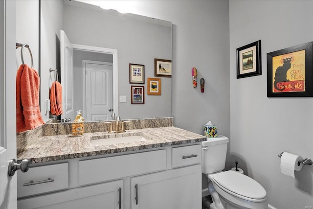 half bath featuring toilet and vanity