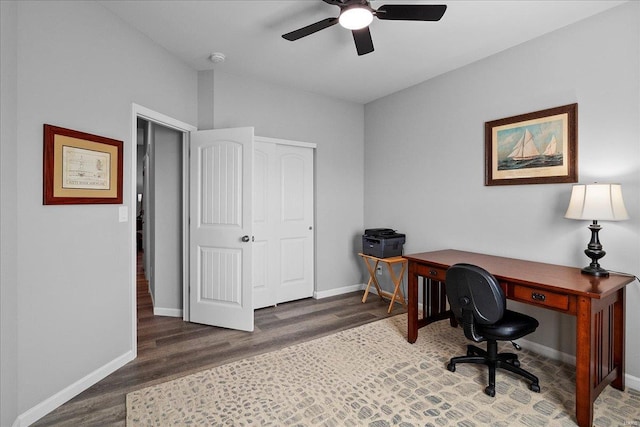 office space featuring baseboards, wood finished floors, and a ceiling fan