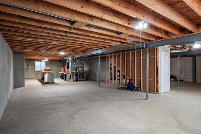 unfinished basement featuring stairway