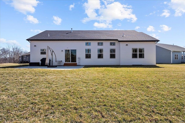 rear view of house with a patio area and a yard