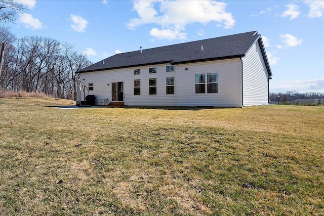 back of property with a patio area and a lawn