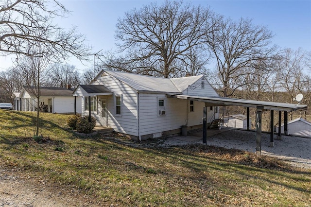 view of side of home featuring a yard and an attached carport