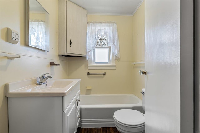 bathroom with toilet, ornamental molding, a bathtub, wood finished floors, and vanity