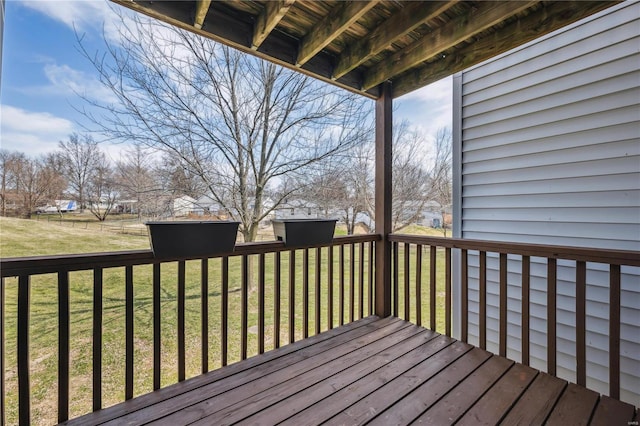 wooden deck featuring a yard