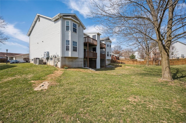 view of side of home featuring cooling unit, a yard, and fence