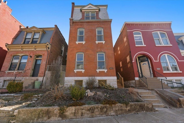 victorian home with brick siding and entry steps