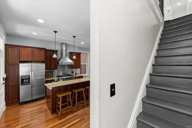 stairs with recessed lighting and wood finished floors